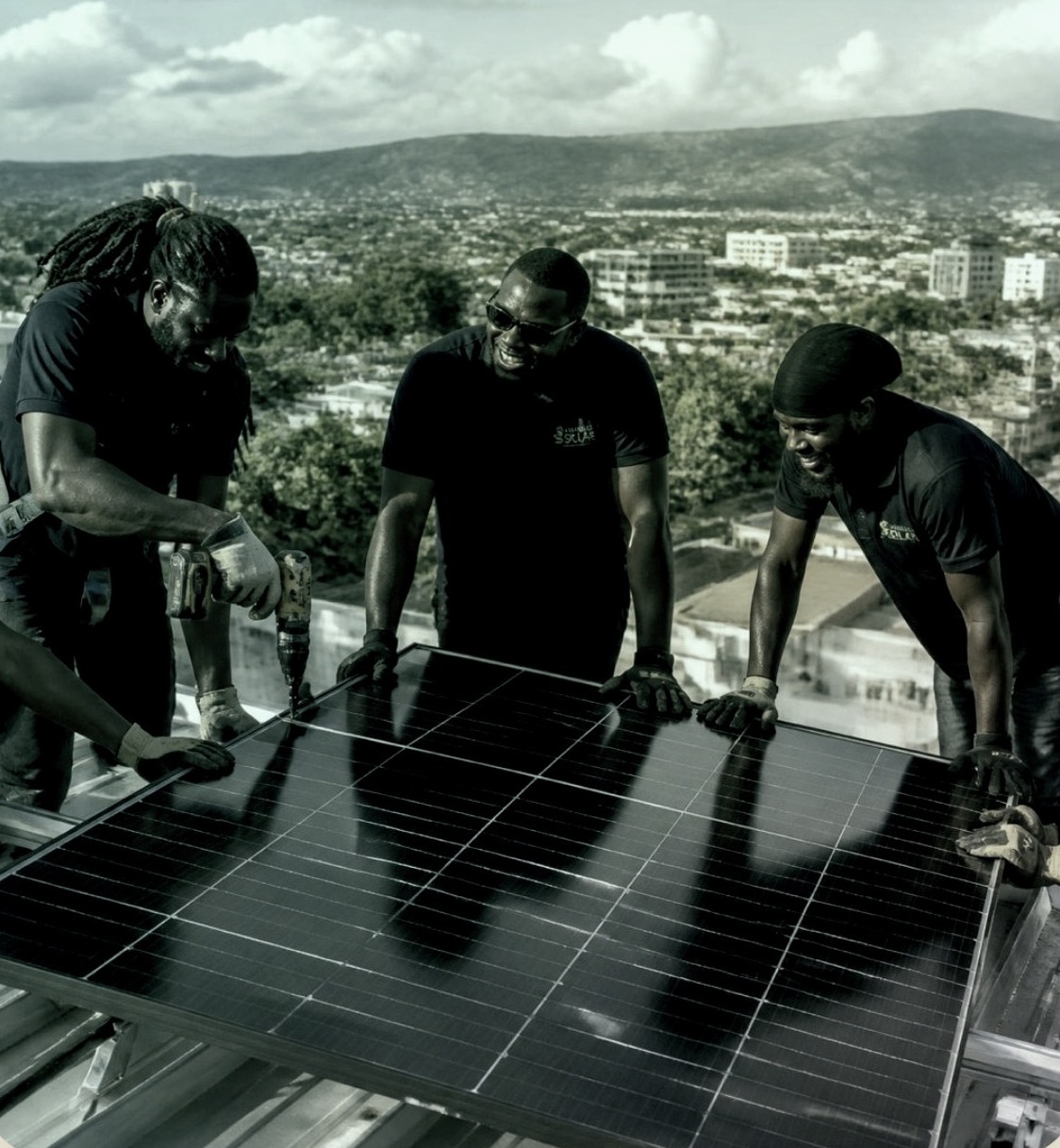 Paragon Renewable team installing solar panels on a Jamaican rooftop